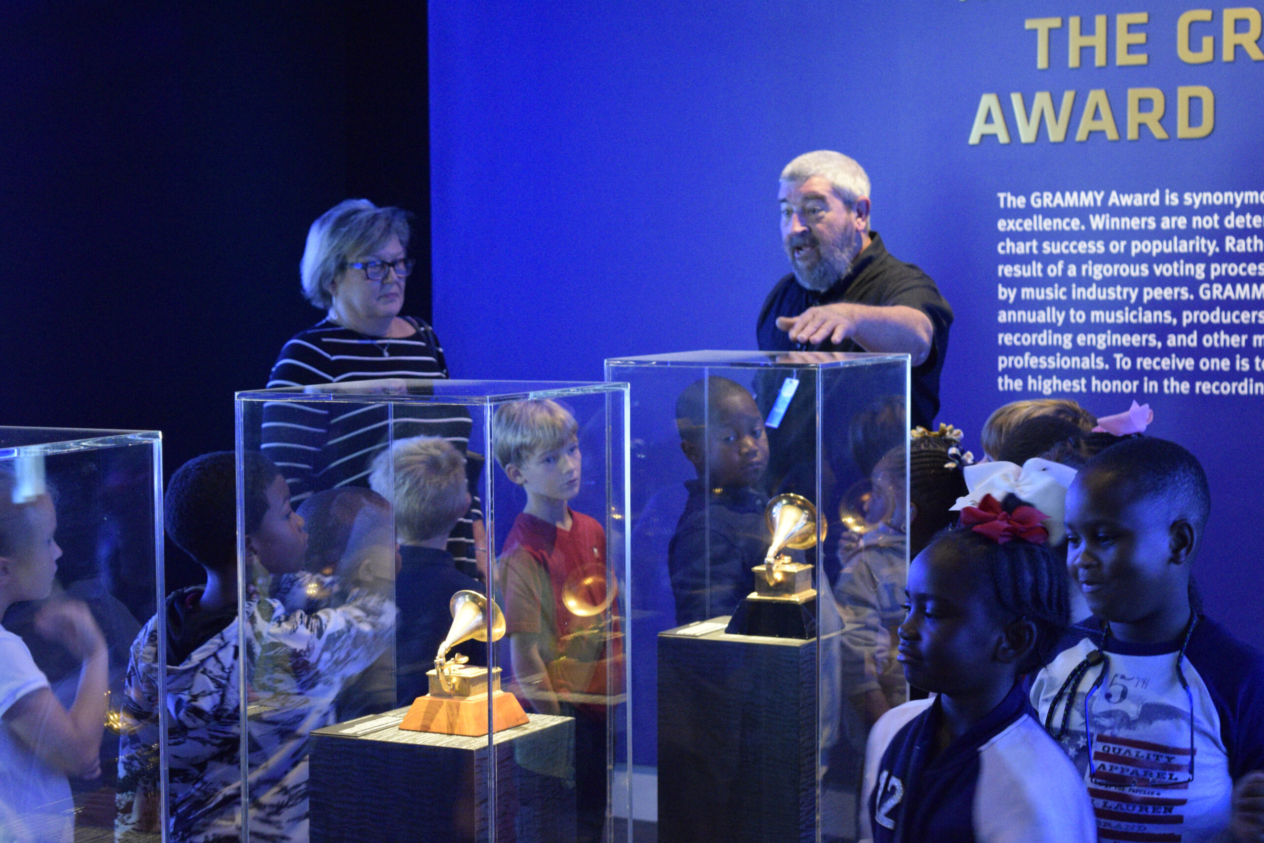 Museum guide explaining a display.