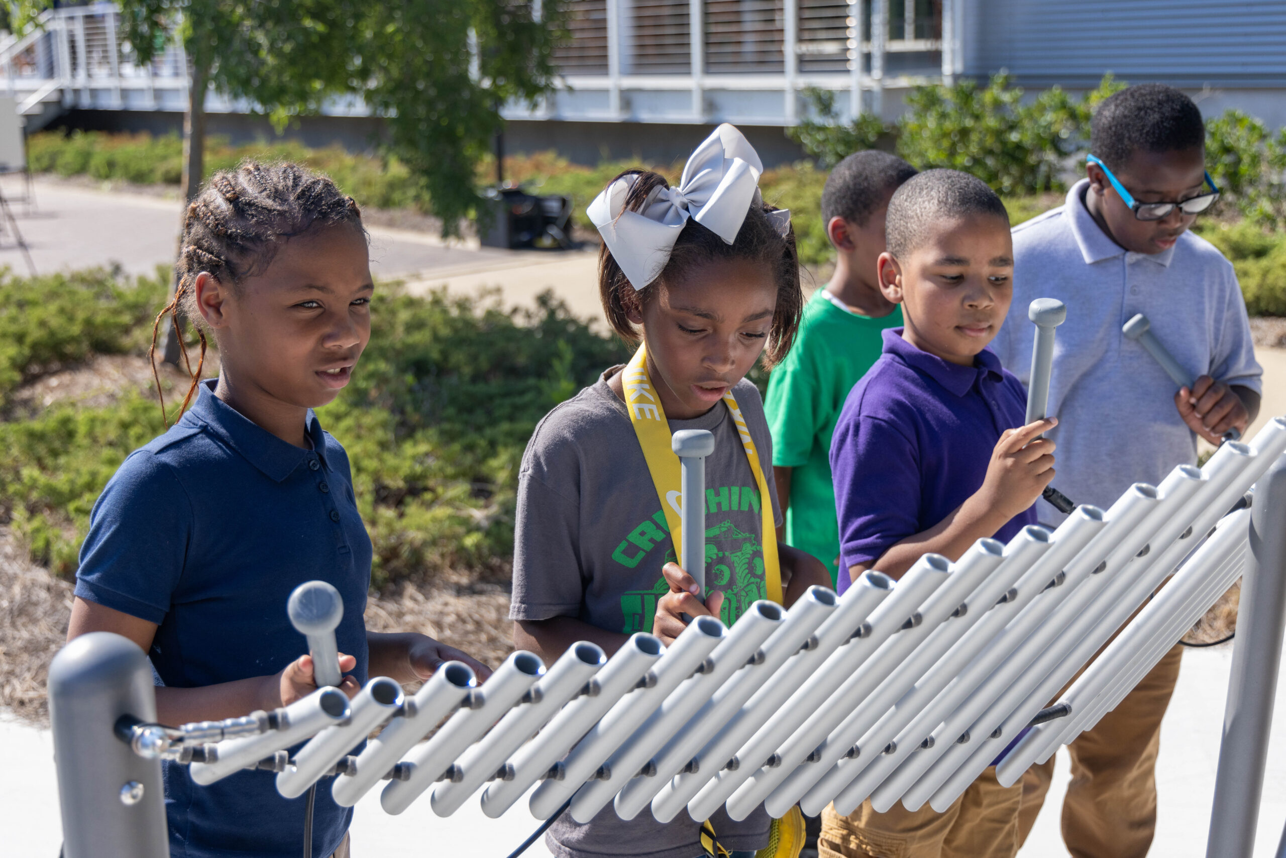 Kids playing with a musical instrument
