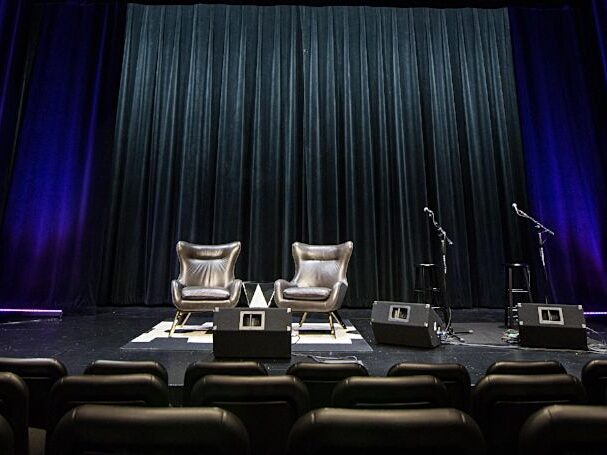 a stage with chairs and microphones