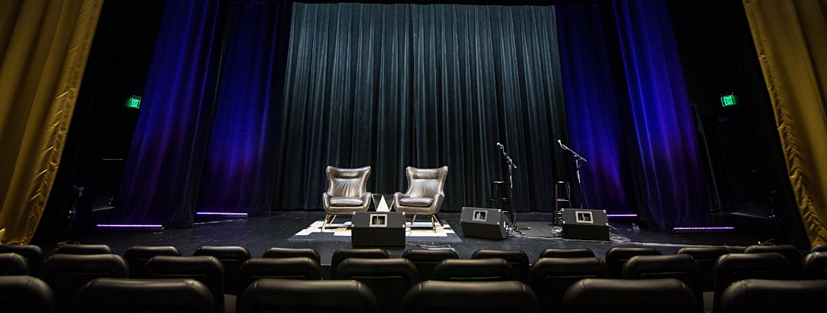 a stage with chairs and microphones