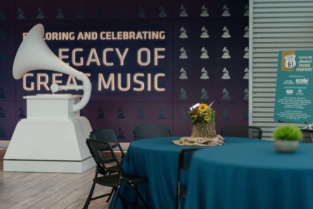 a table with chairs and a vase of flowers on it