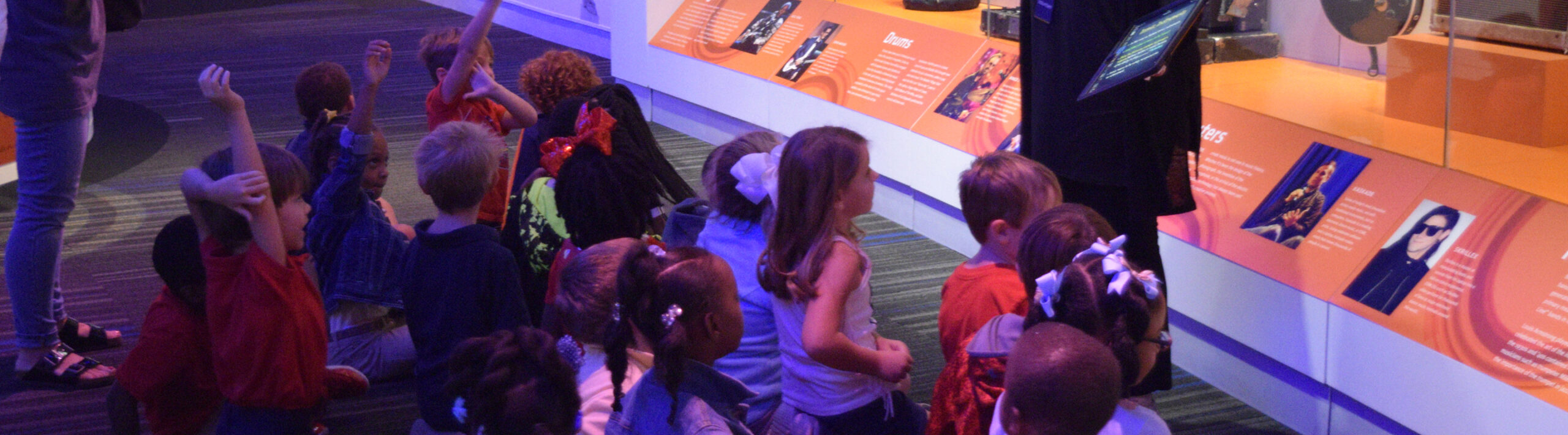 a group of children sitting in a room