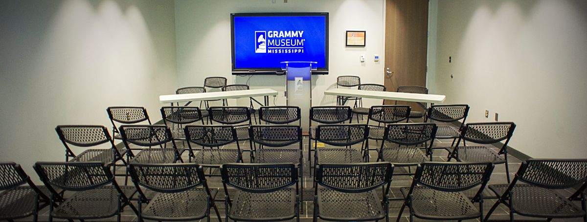 a room with chairs and a screen