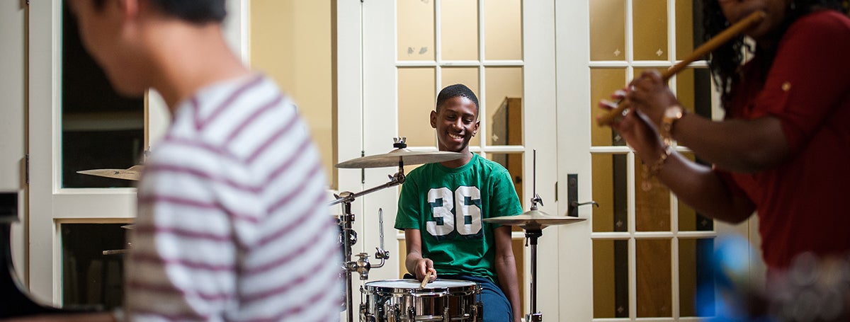 a boy playing a drum set